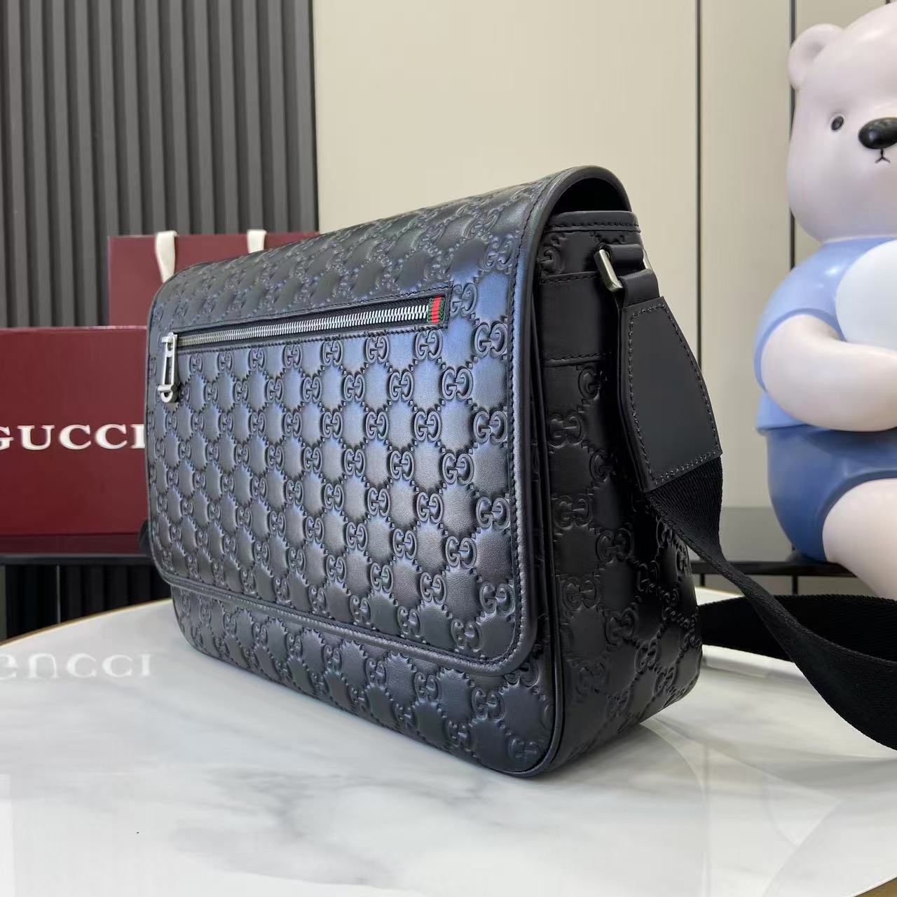 Blue embossed GG flap crossbody bag with black strap and gold-tone hardware