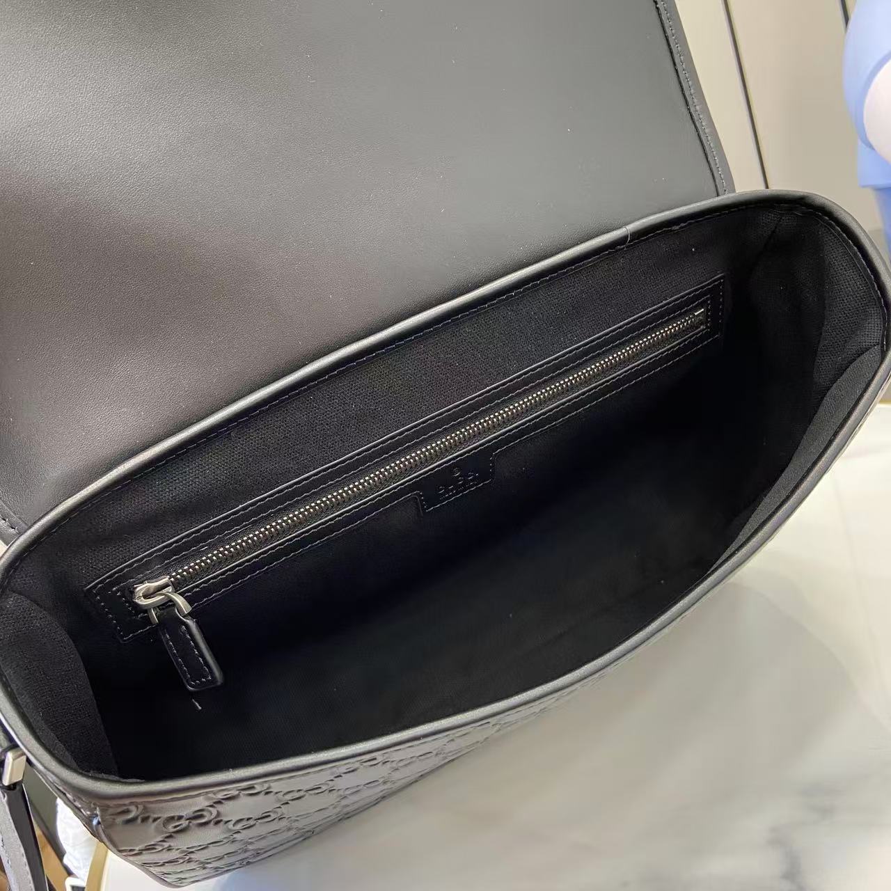 Blue GG crossbody bag interior with zip pocket and gold-tone zipper hardware