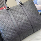 Gucci bag with embossed GG pattern and black leather handles