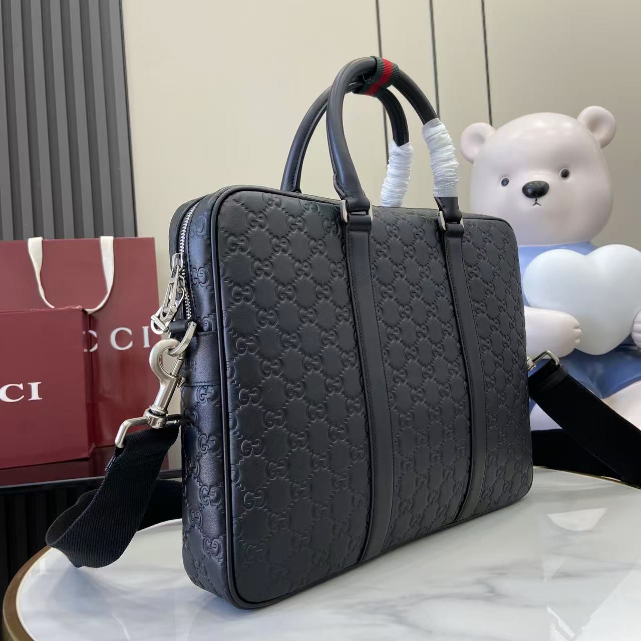 Gucci handbag with navy GG monogram, top handles and adjustable shoulder strap