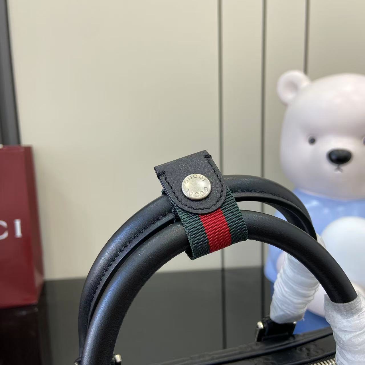 Gucci bag top handle with webbing strap and logo snap