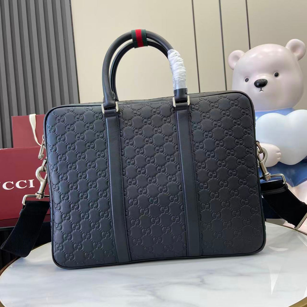 Gucci handbag in navy with GG monogram, dual handles and shoulder strap