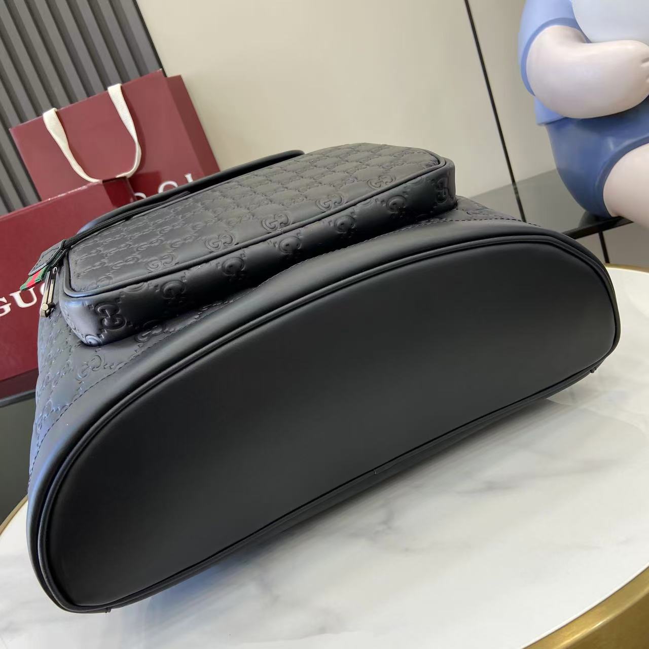 Gucci bag with curved top and embossed GG pattern, dark gray-black exterior
