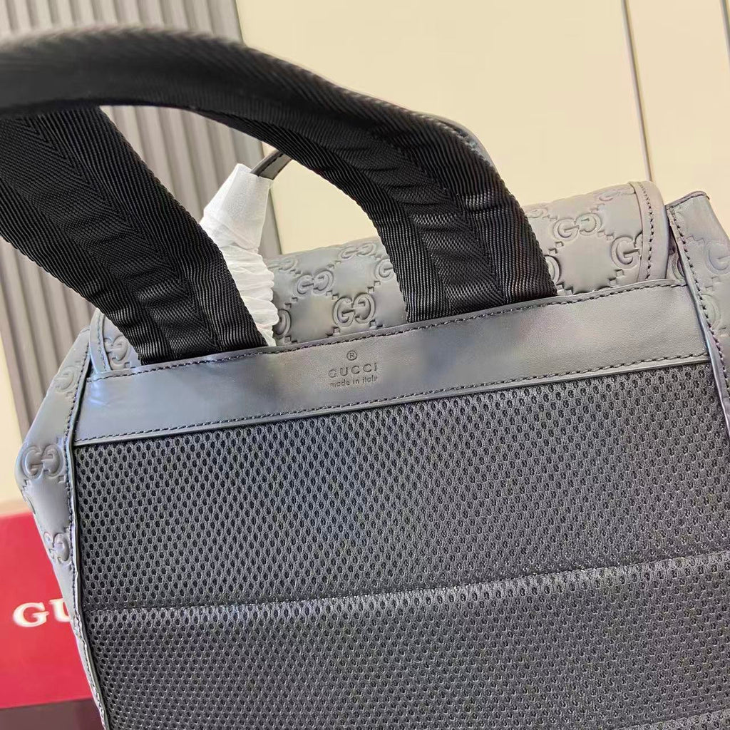 Gucci bag top handles with logo label and textured panel, light blue-gray exterior