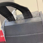 Gucci bag top handles with logo label and textured panel, light blue-gray exterior