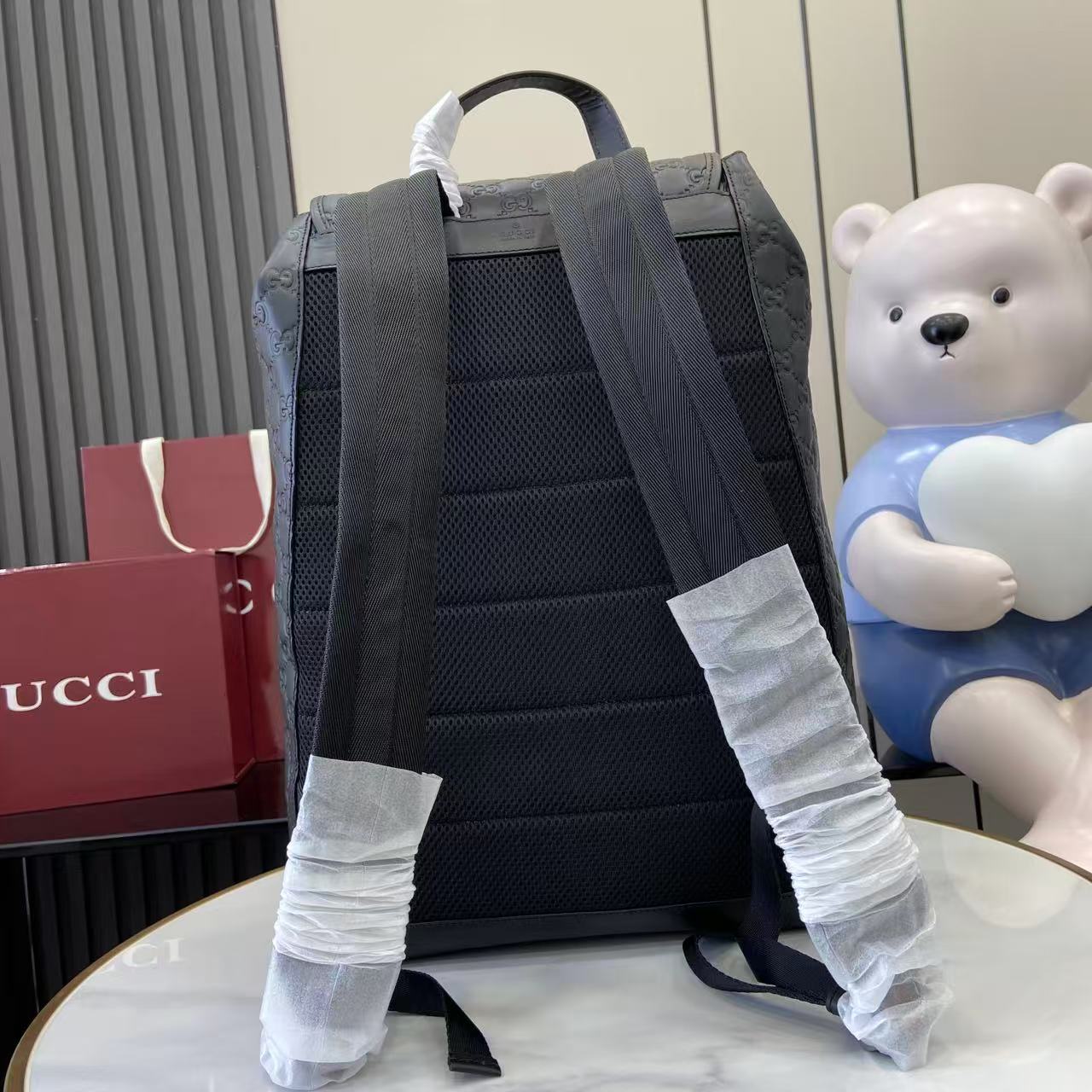 Gucci bag backpack back view with adjustable padded straps, dark blue-gray