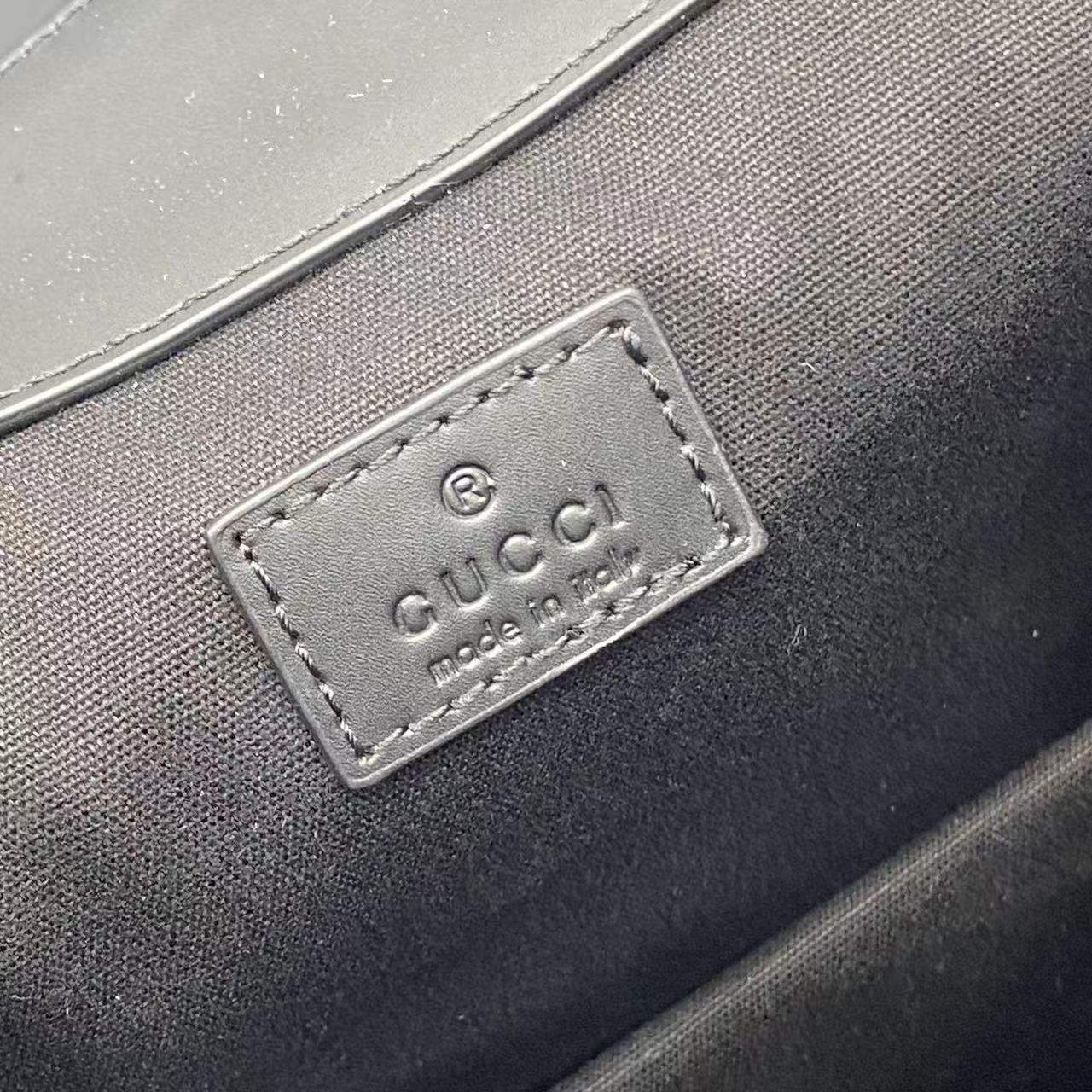 Gucci logo leather patch on inner lining of bag, rectangular with stitched border