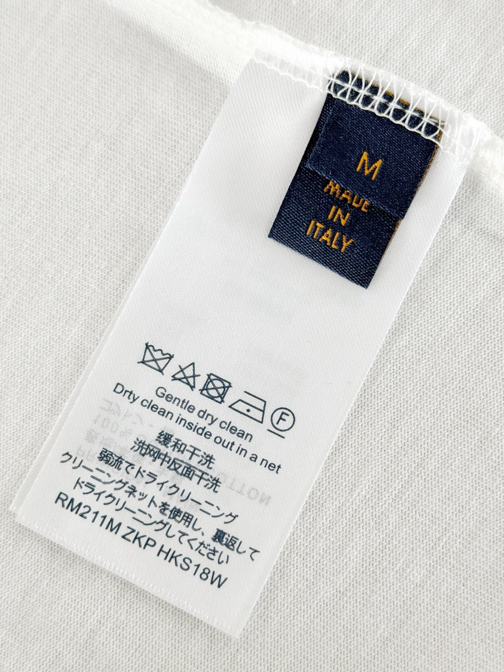 Louis Vuitton T-shirt size and care label, navy tag on white fabric