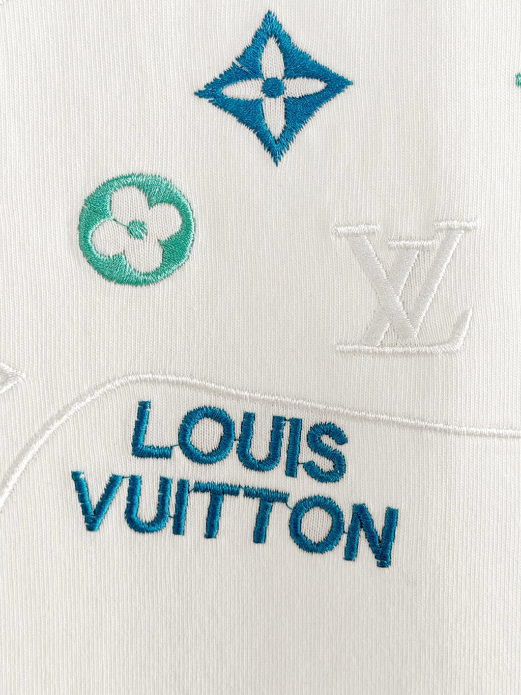 Louis Vuitton white T-shirt fabric closeup with Louis Vuitton logo