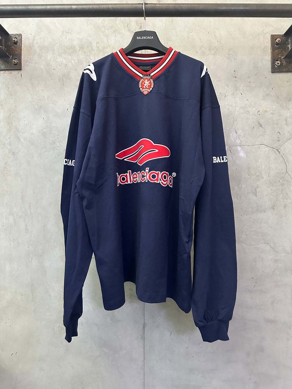 Balenciaga navy long-sleeve sweatshirt with red logo and striped ribbed collar