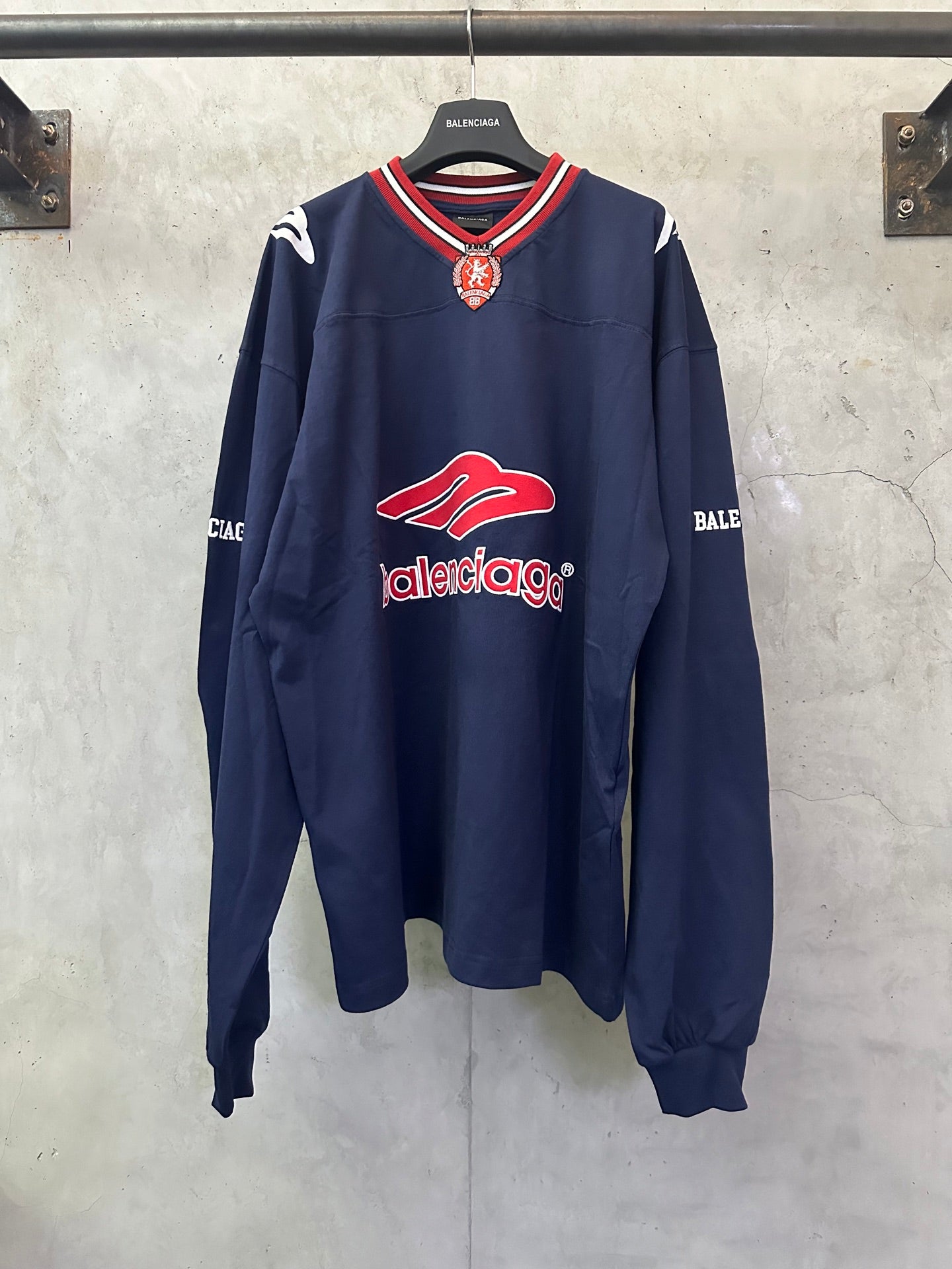 Balenciaga navy long-sleeve sweatshirt with red logo and striped ribbed collar