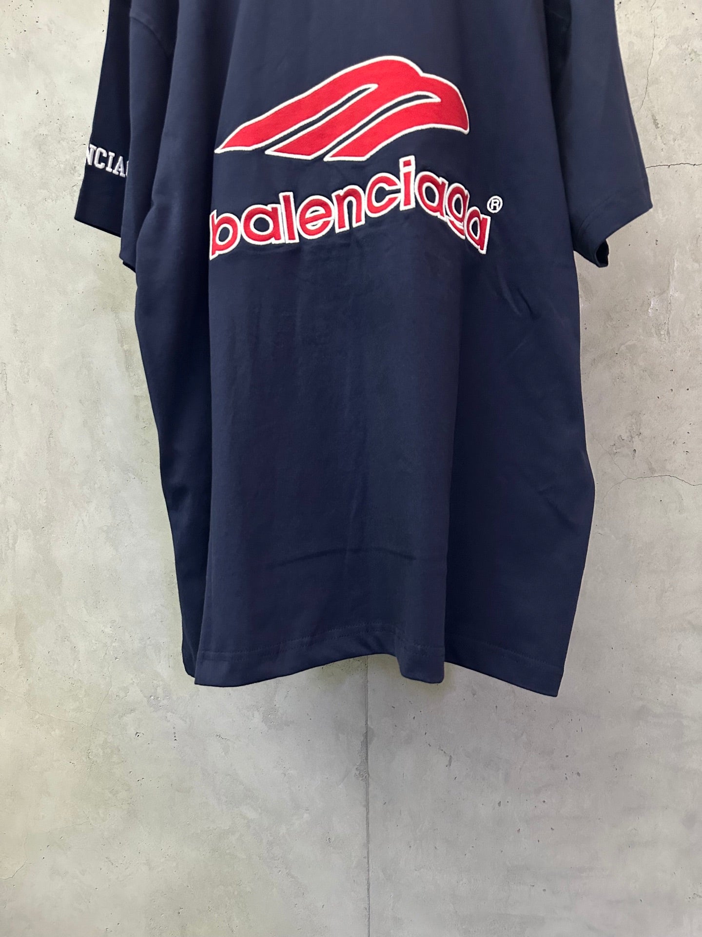 Navy short-sleeve polo shirt with red Balenciaga graphic logo on back
