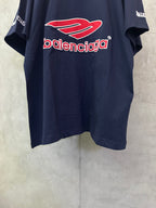 Navy short-sleeve polo shirt with large red Balenciaga logo centered on front