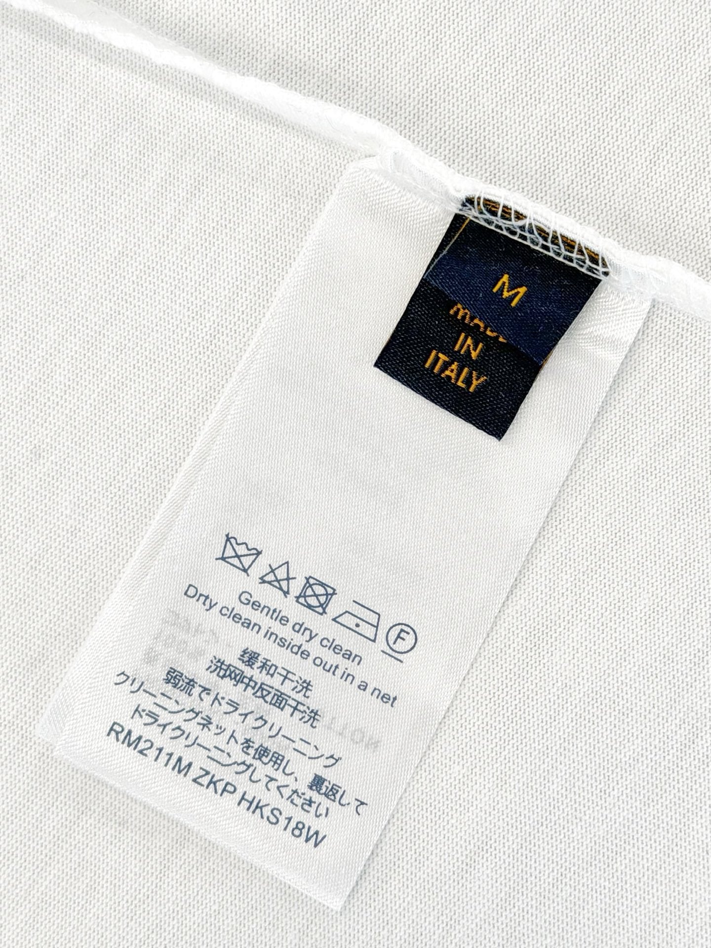 White T-shirt interior care label with size M and Made in Italy text