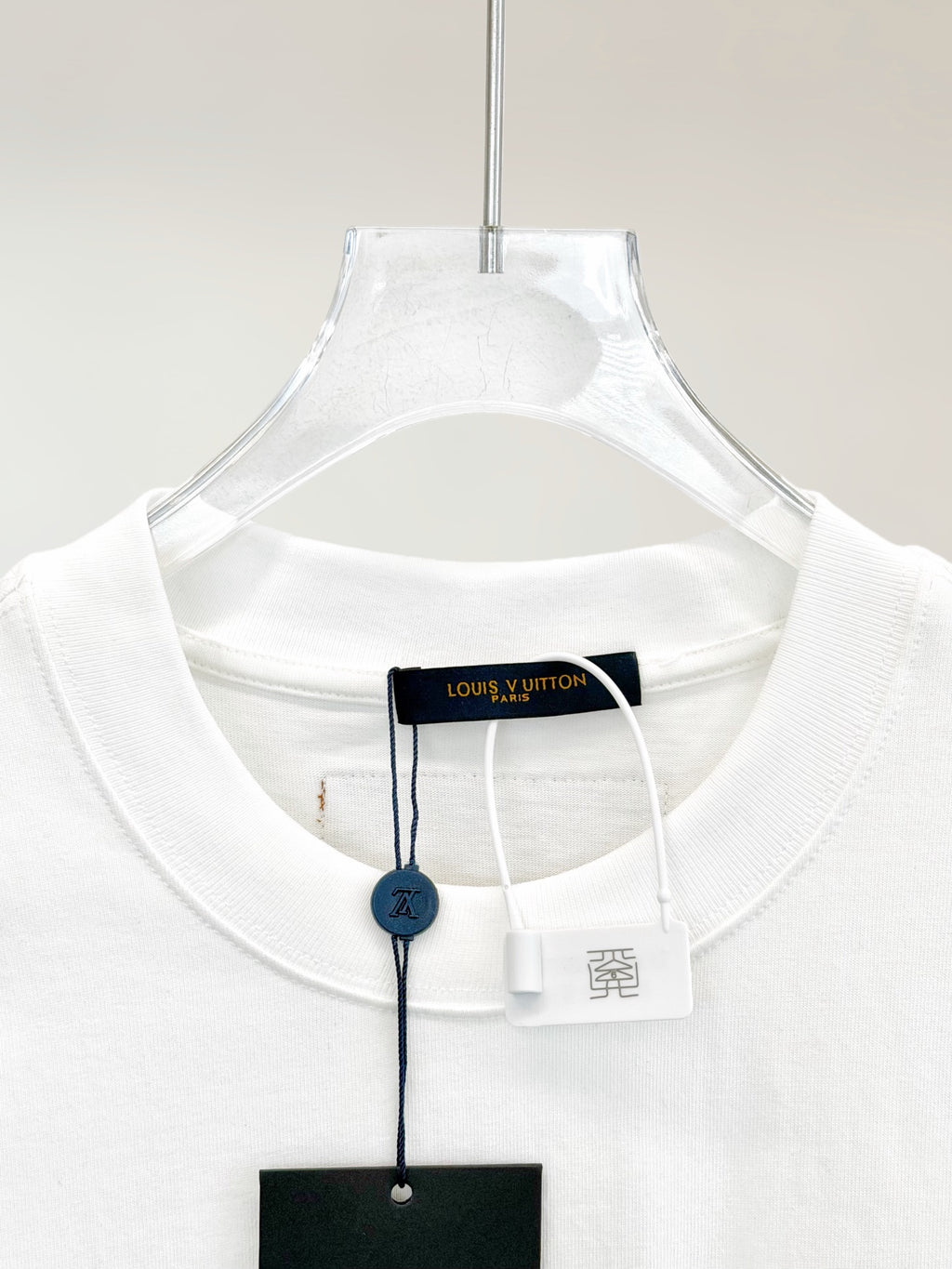White T-shirt neckline with brand hang tag and inner neck label