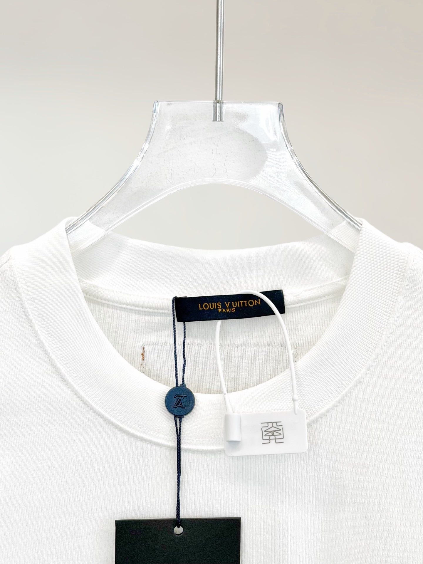 White T-shirt neckline with brand hang tag and inner neck label