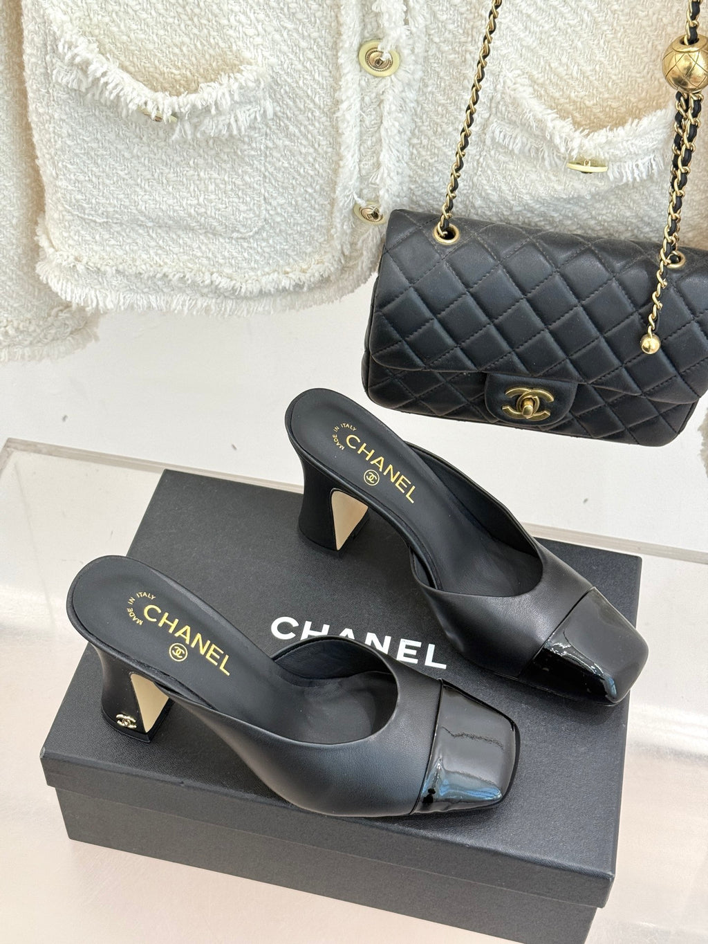Black Chanel heeled mules with gold logo on front strap