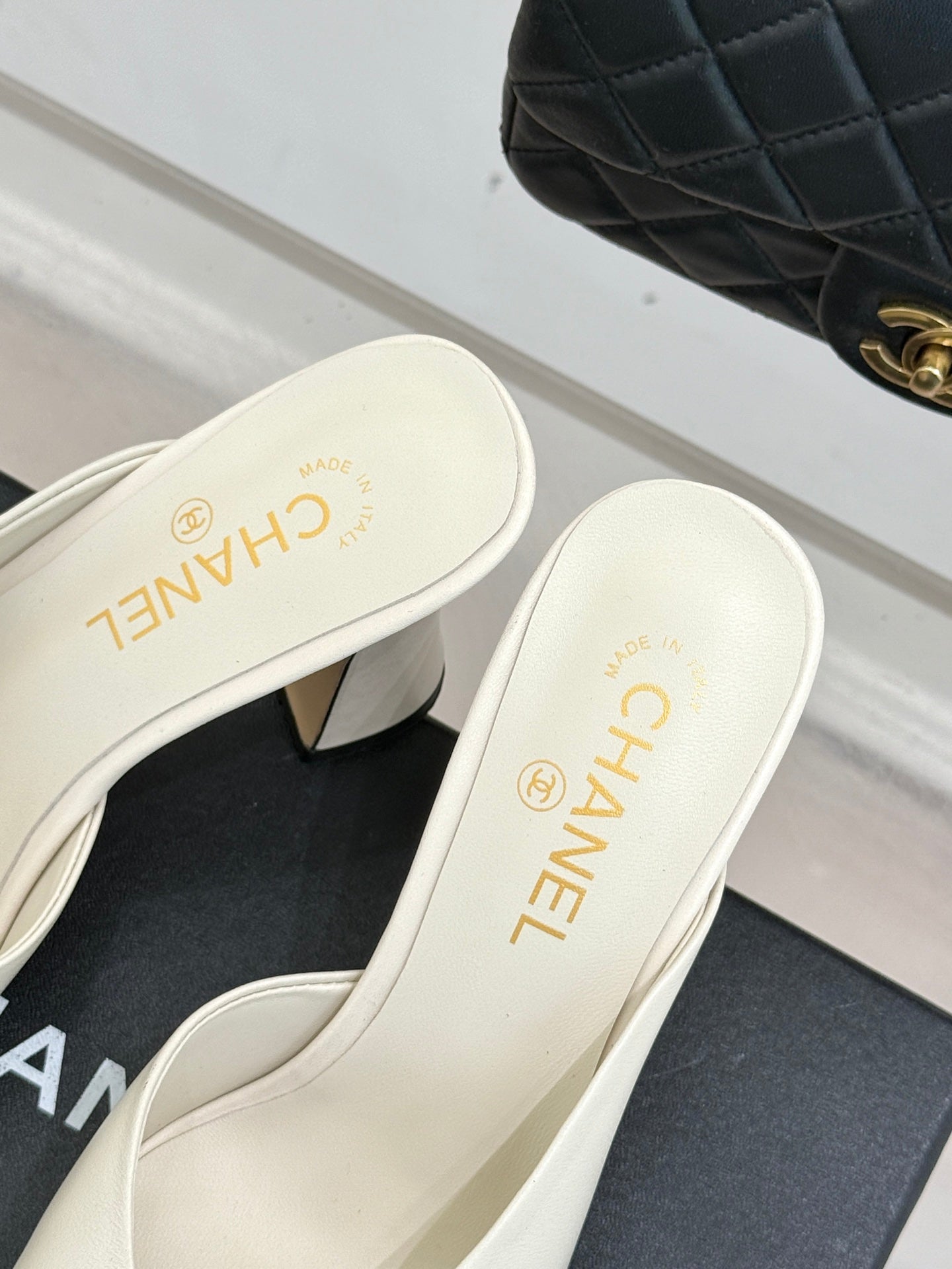 Chanel ladies mule heel view, white insole with black patent toe