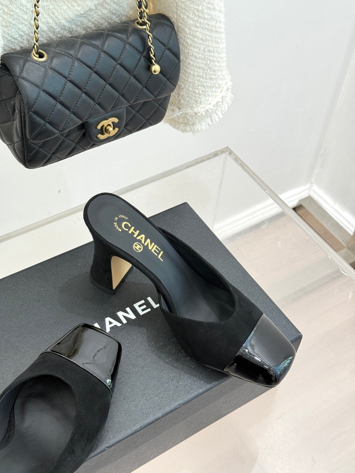 Black heeled slide sandals with gold heel detail and glossy square toe caps