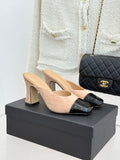 Beige suede mules with black patent cap toe and block heel, side buckle detail