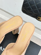 Beige mule insoles with embossed text and black patent toe panels