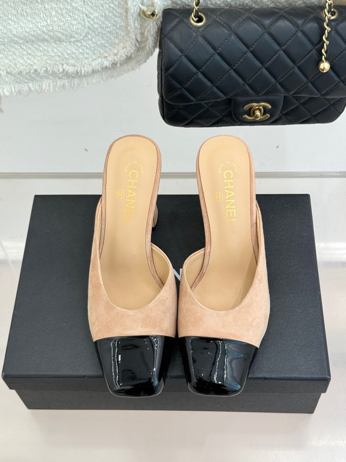 Beige suede mule sandals with black patent toe blocks and mid block heels