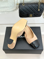 Beige suede mules with black patent toe strap and block heel, side view