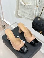 Pair of beige suede mules with black patent square toe and block heels