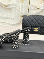 Close view of black mule heels with white spots and mint green patent toe