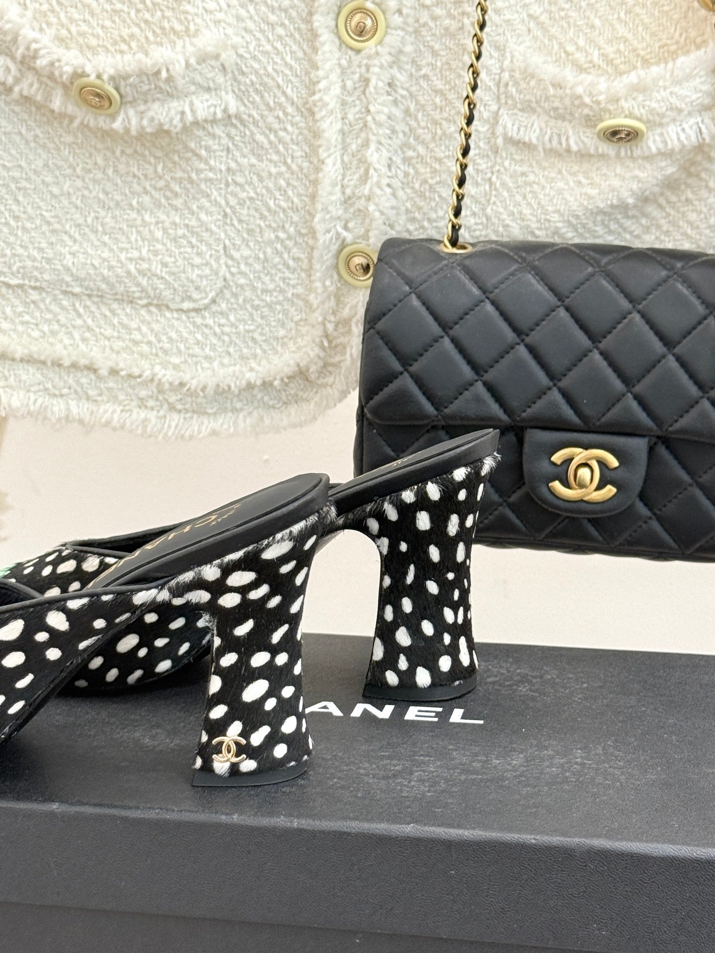 Close view of black mule heels with white spots and mint green patent toe