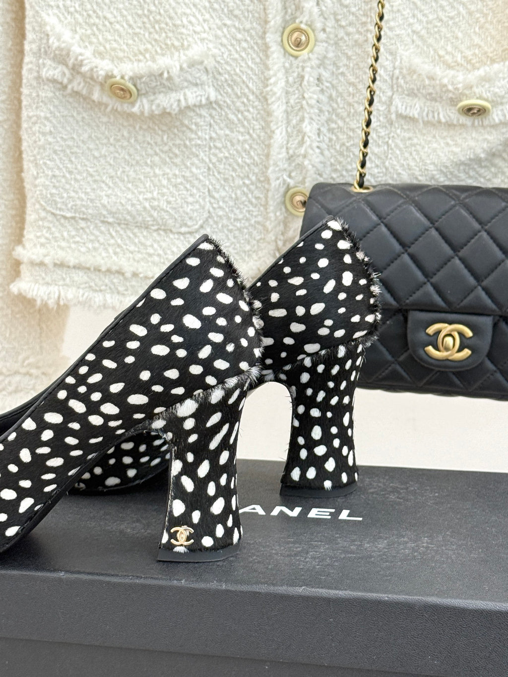 Polka-dot black high heels with red glossy toe cap, heel and toe close-up.