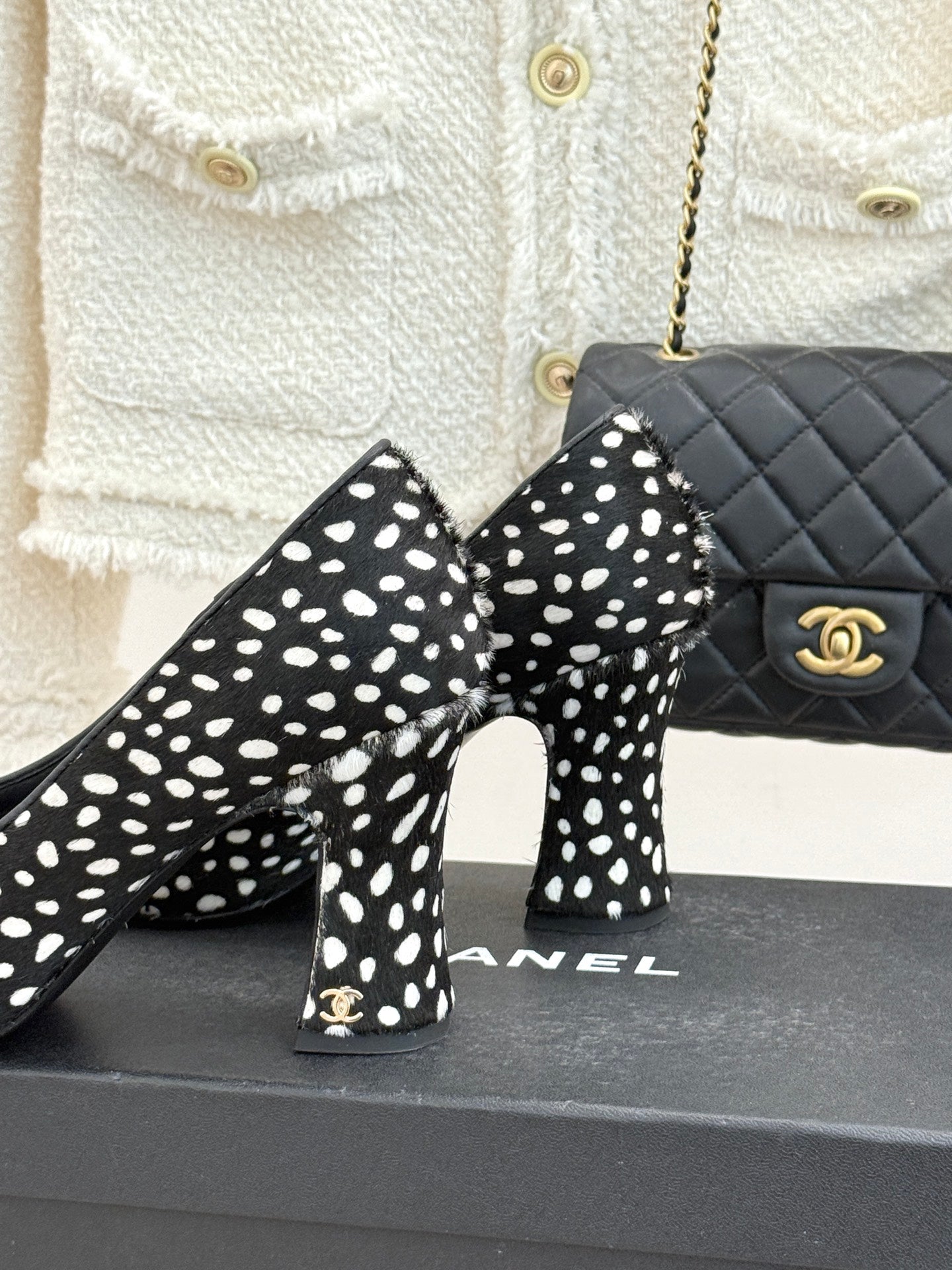 Polka-dot black high heels with red glossy toe cap, heel and toe close-up.