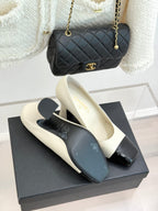 White heeled shoes with glossy black toe cap and slim ankle strap