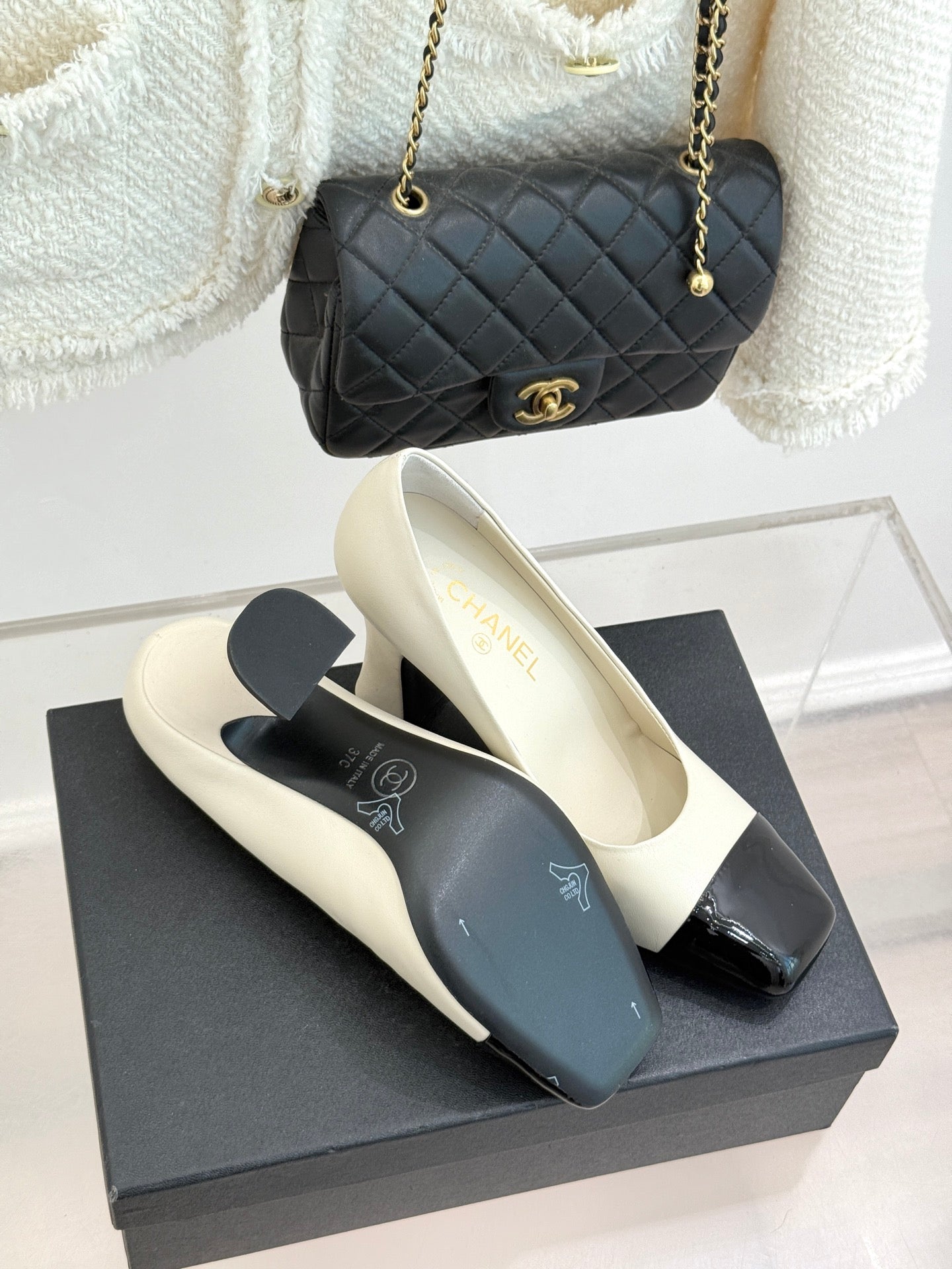 White heeled shoes with glossy black toe cap and slim ankle strap