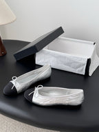 Two-tone leather ballet flats with lace-up bows, side view