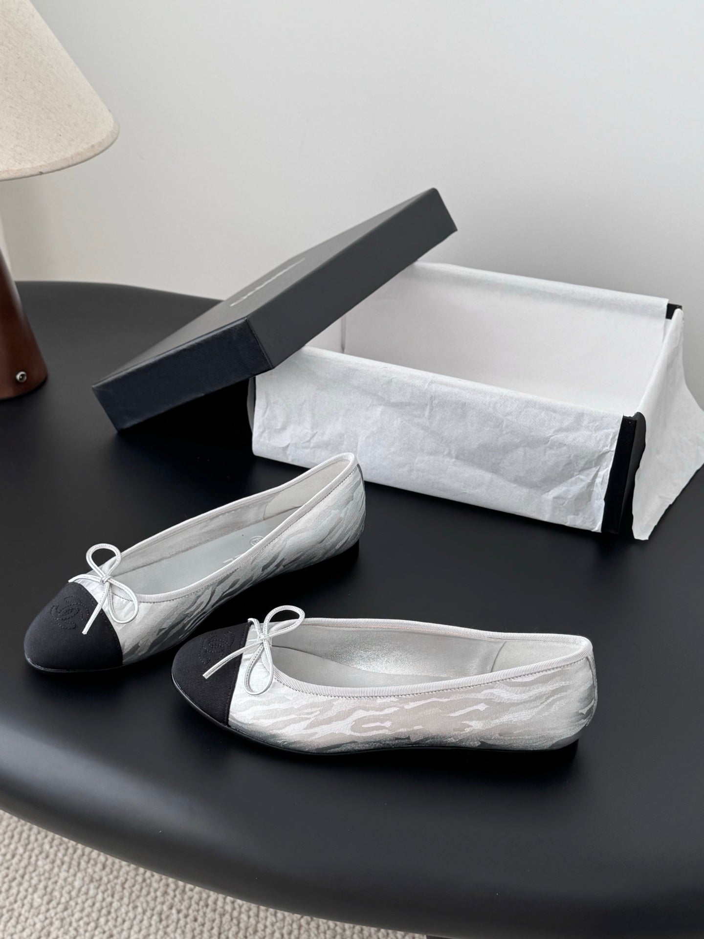 Two-tone leather ballet flats with lace-up bows, side view