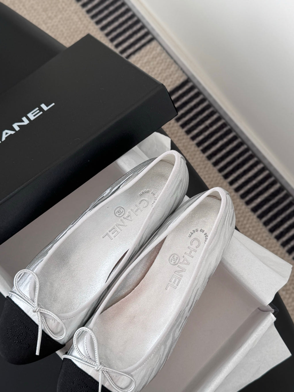 Two-tone leather ballet flats with lace-up bows, close-up on uppers