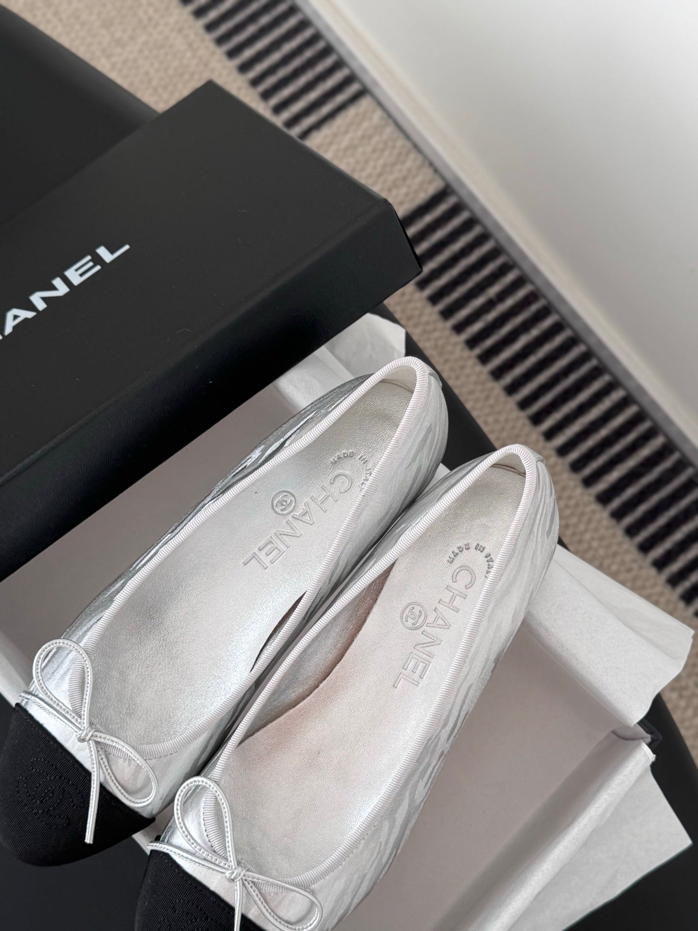 Two-tone leather ballet flats with lace-up bows, close-up on uppers