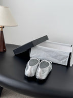 Two-tone leather ballet flats with lace-up bows, front view