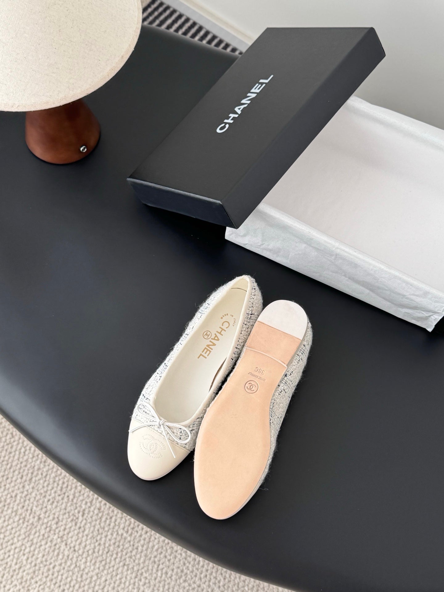 Cream tweed flats with bow ties and tan insole, shown with shoe box