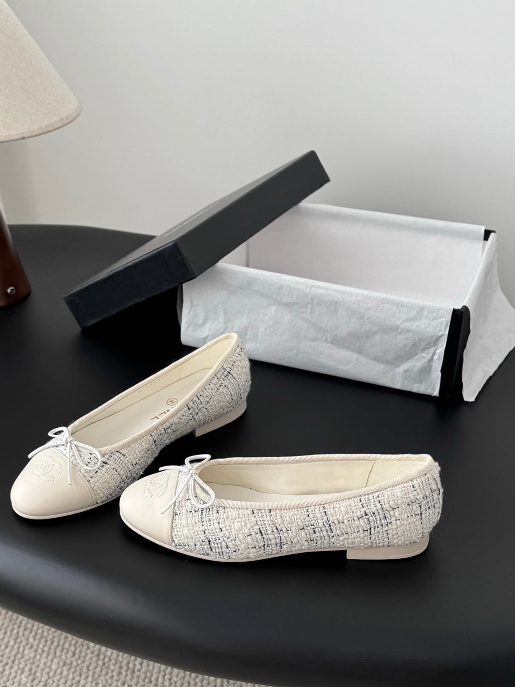 Pair of cream tweed ballet flats with bow ties, presented with shoe box