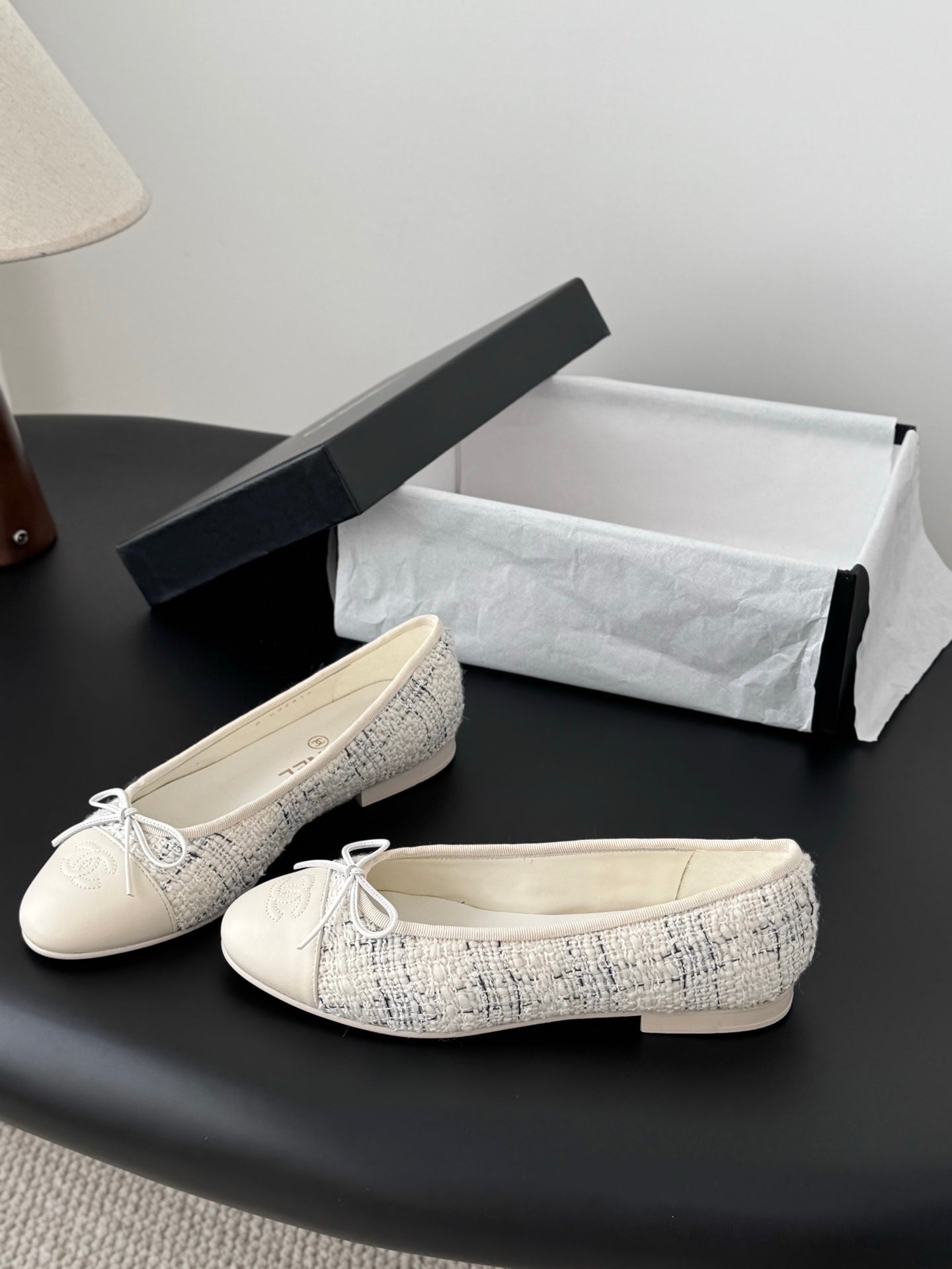Pair of cream tweed ballet flats with bow ties, presented with shoe box