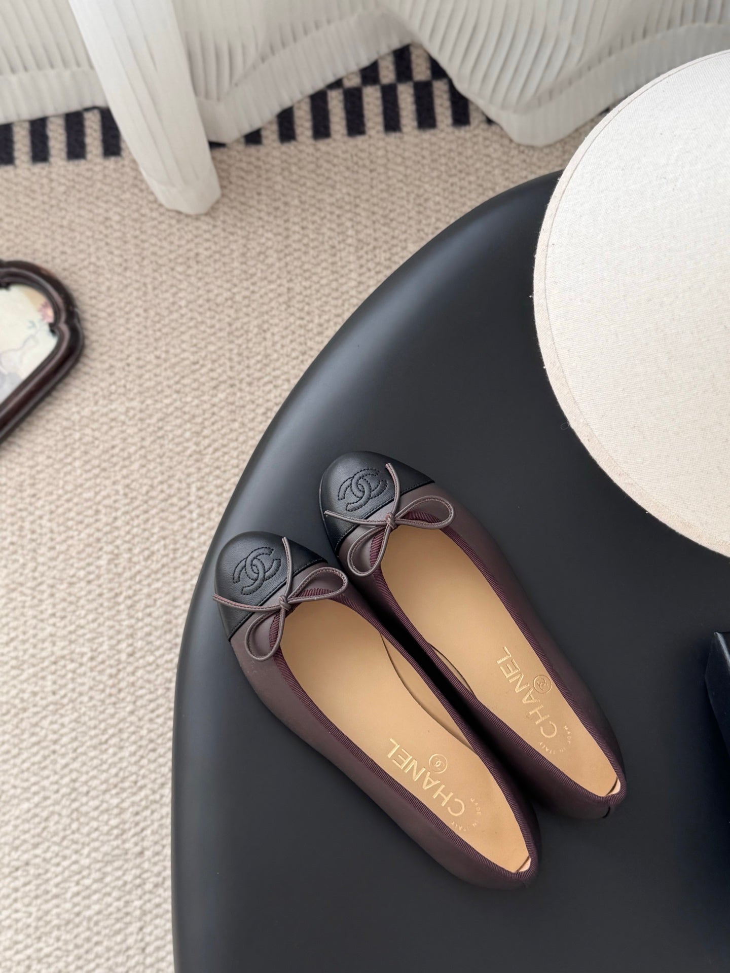 Chanel ballet flats on floor, round toe with bow and logo emblems