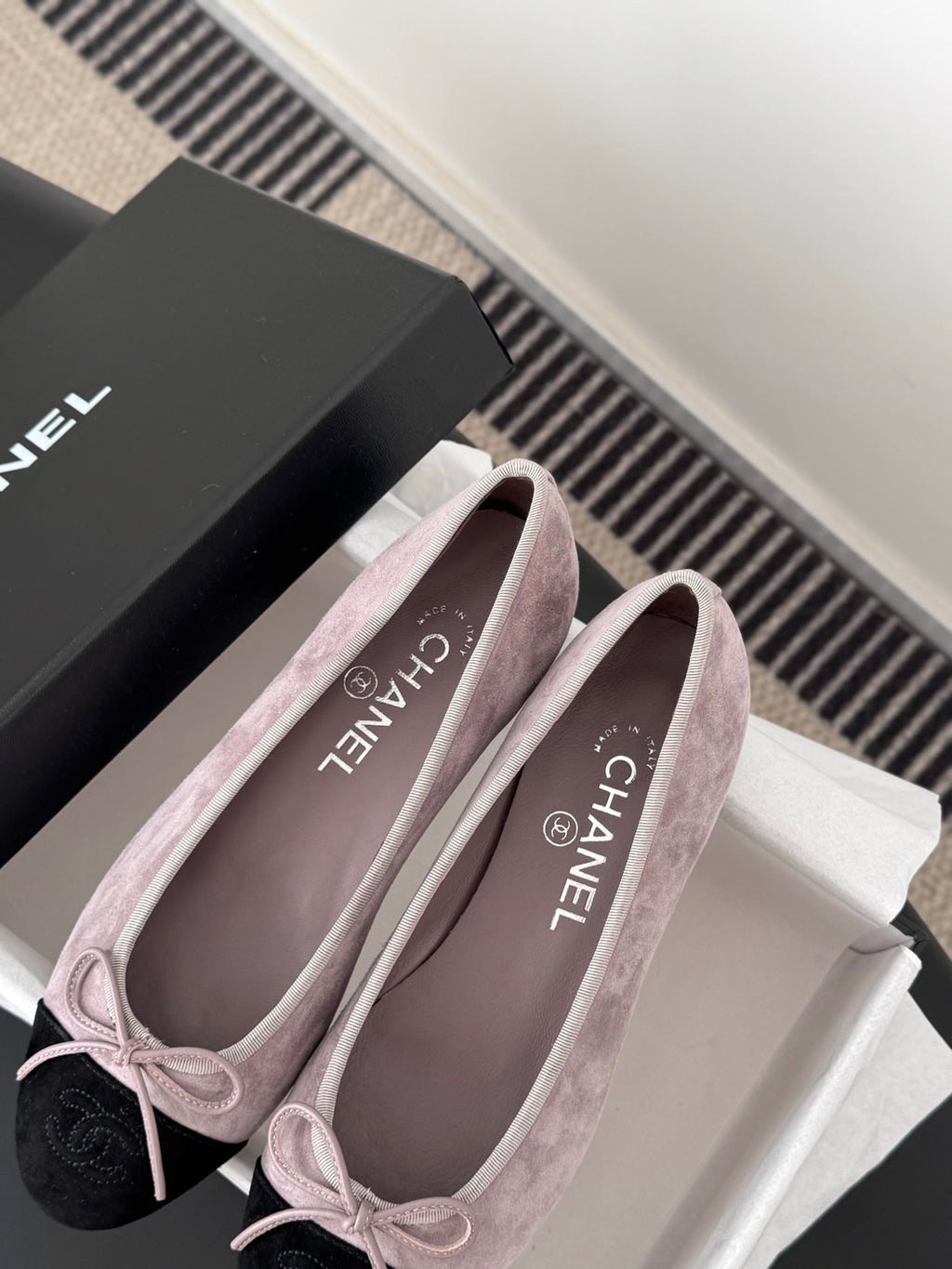 Chanel suede ballet flats with mauve uppers, black toe tips, and CHANEL insole text