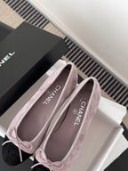 Chanel suede ballet flats with mauve uppers, black toe tips, and CHANEL insole text