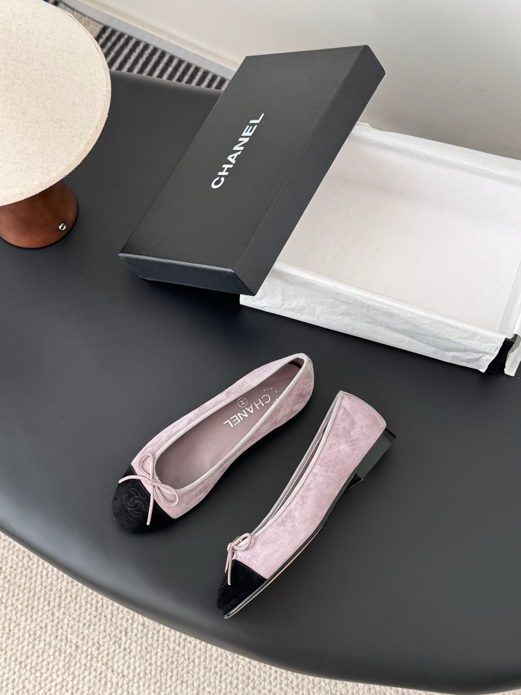 Chanel suede ballet flats with black toe tips and pink bow detail on uppers