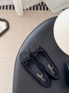 Dark lace-up ballet flats with bow laces, top view, logo insoles