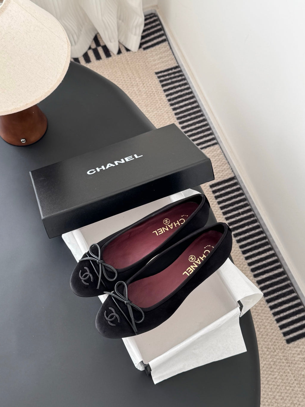 Chanel womens ballet flats, dark fabric, lace-up ribbon bows, pair on curved tray