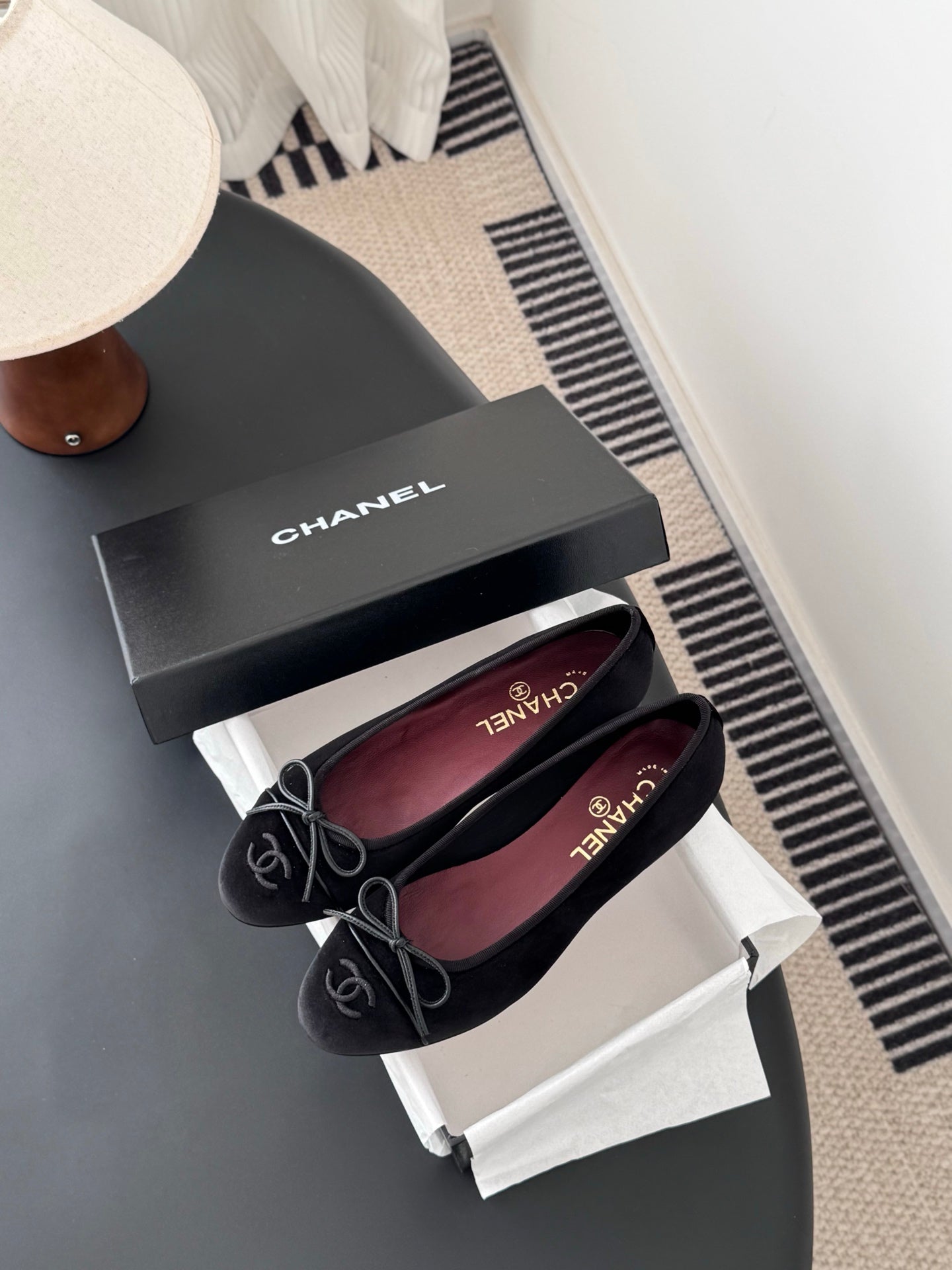 Chanel womens ballet flats, dark fabric, lace-up ribbon bows, pair on curved tray