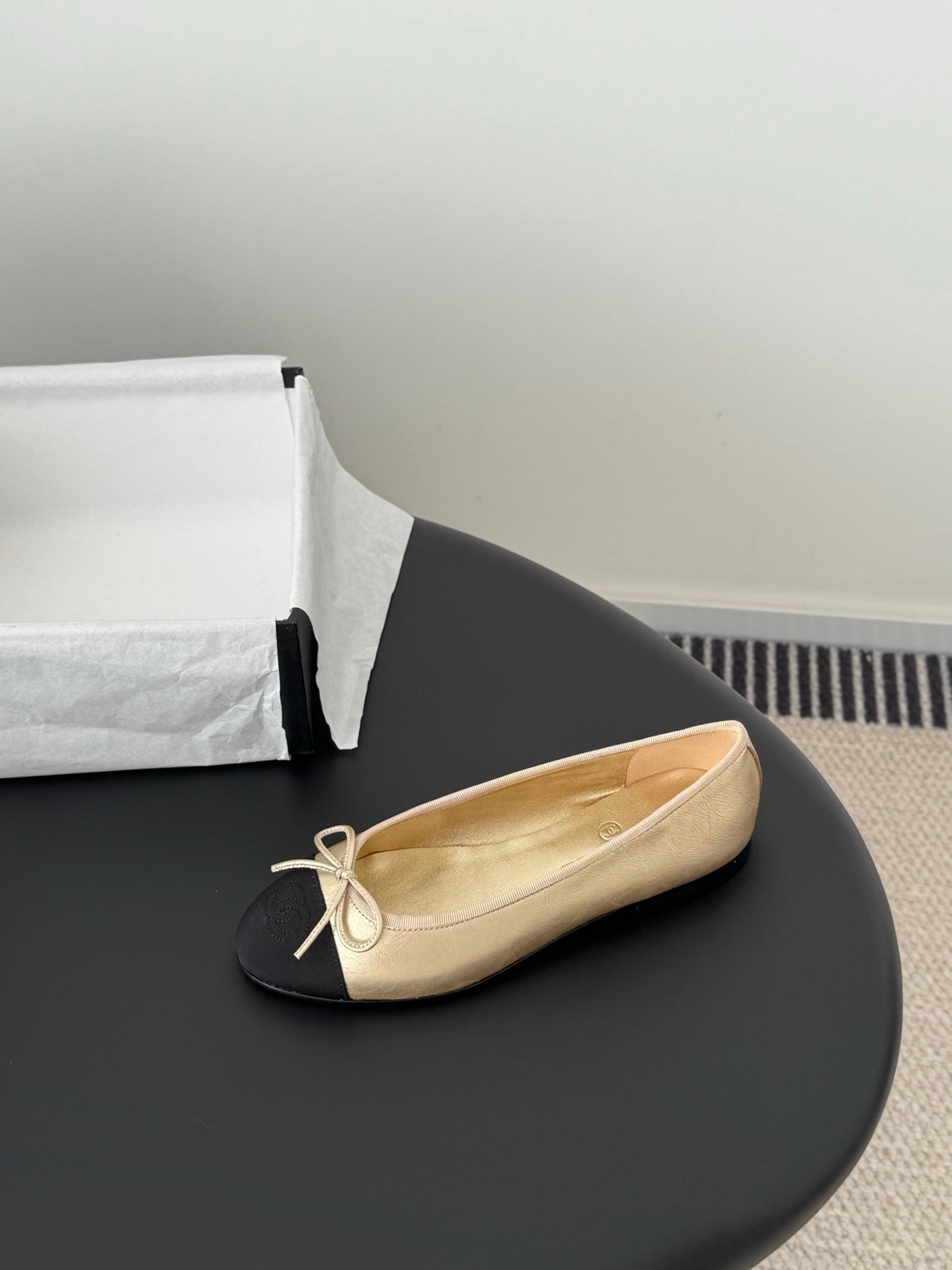 Chanel ladies ballet flat, beige leather upper with black toe and bow laces
